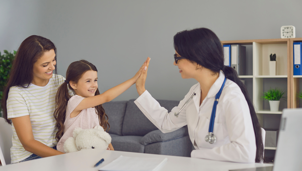 female doctor laughing with a woman and child (1)-1