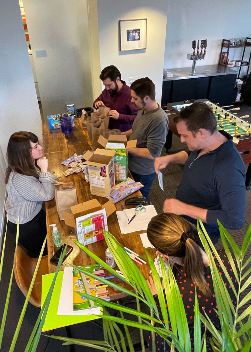 Productive Edge staff packing breakfast food for a charity event.