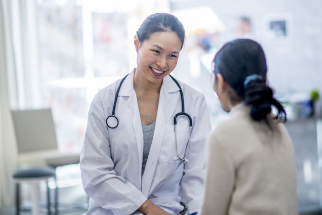 a happy doctor speaking with a patient