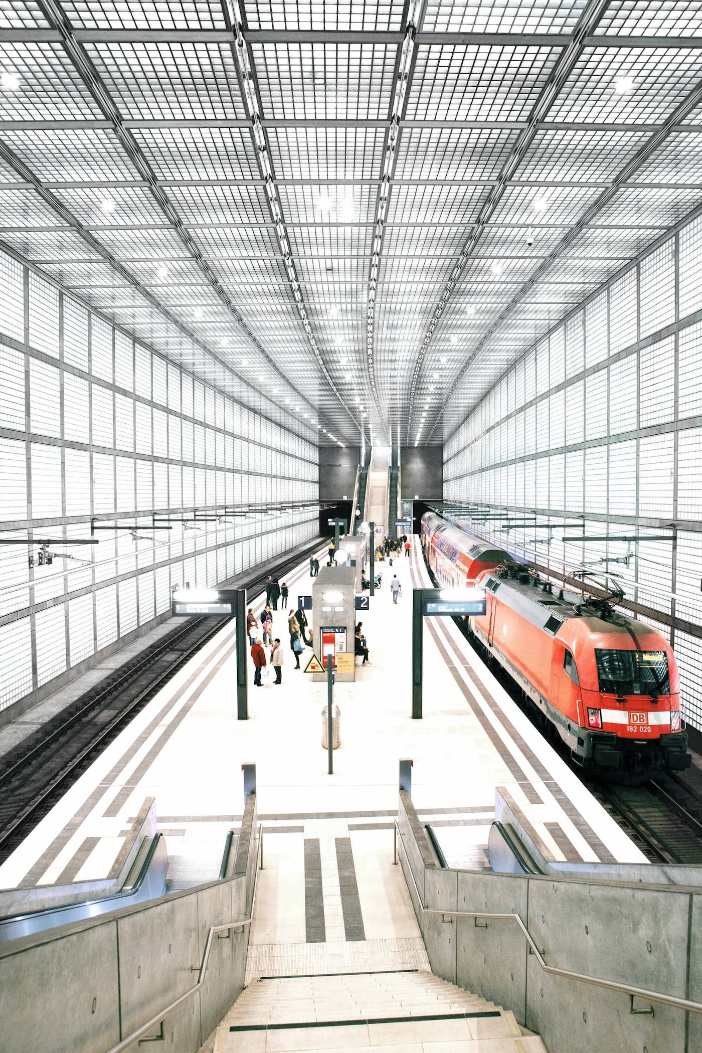 The interior of a busy, brightly lit train station.