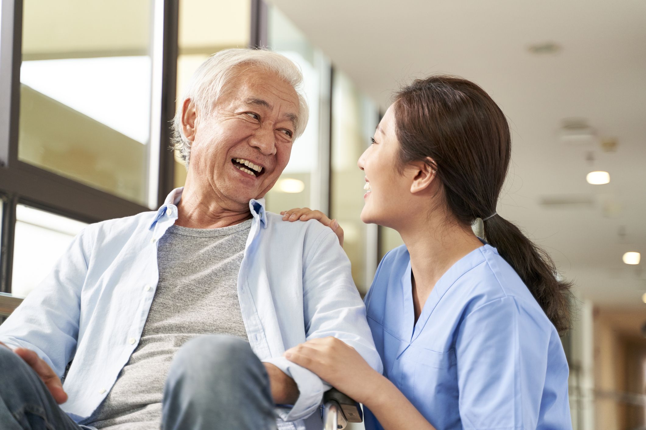 a nurse smiling with a senior patient 
