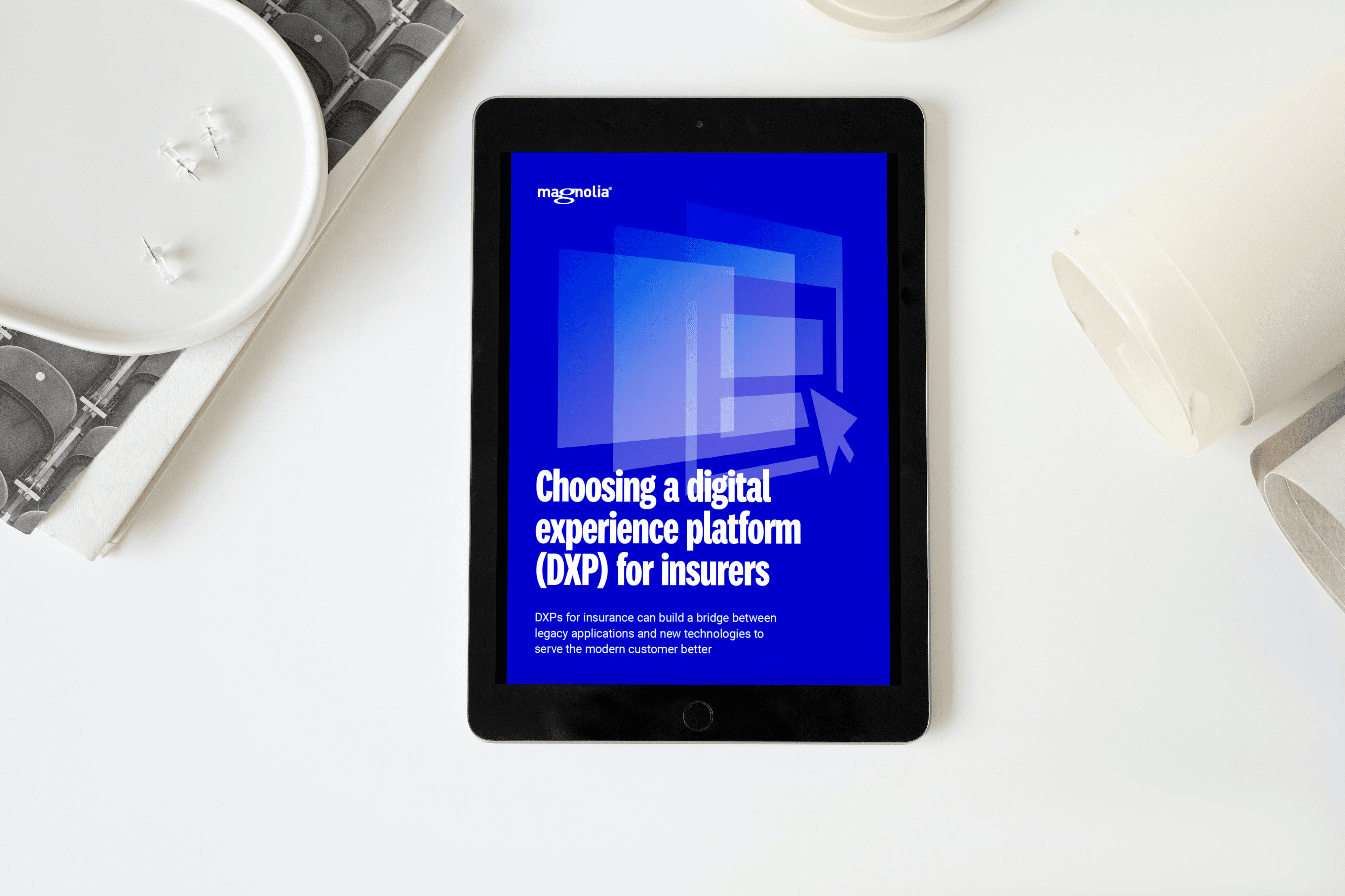 A tablet on a table shows the cover that says Choosing a digital experience platform for insurers.