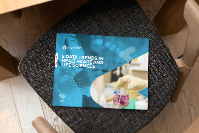 A portrait hard cover book on a chair shows the title 5 Data Trends in Healthcare.