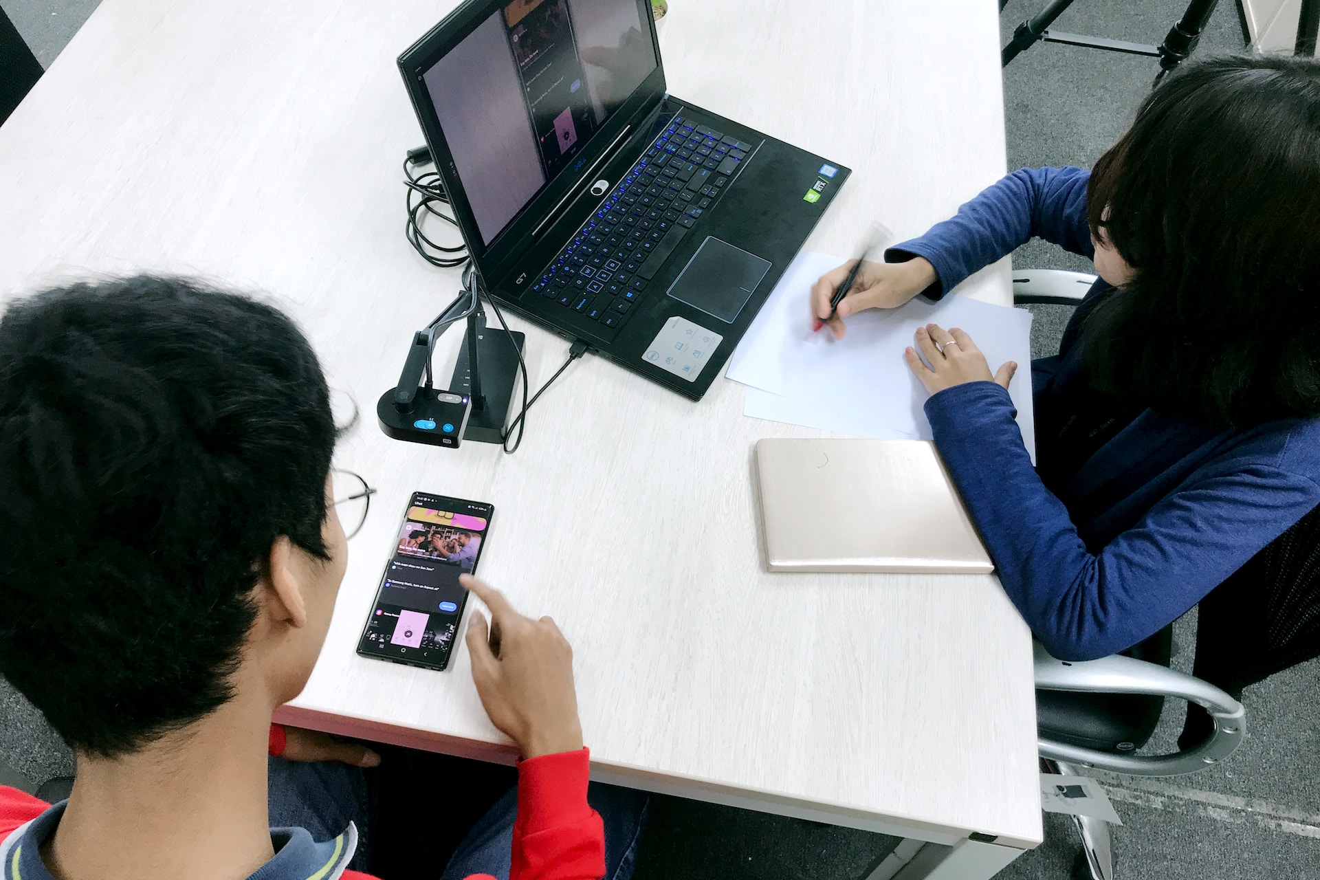 Two people performing mobile app usability testing.