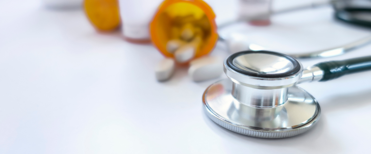 stethoscope next to a prescription pill bottle