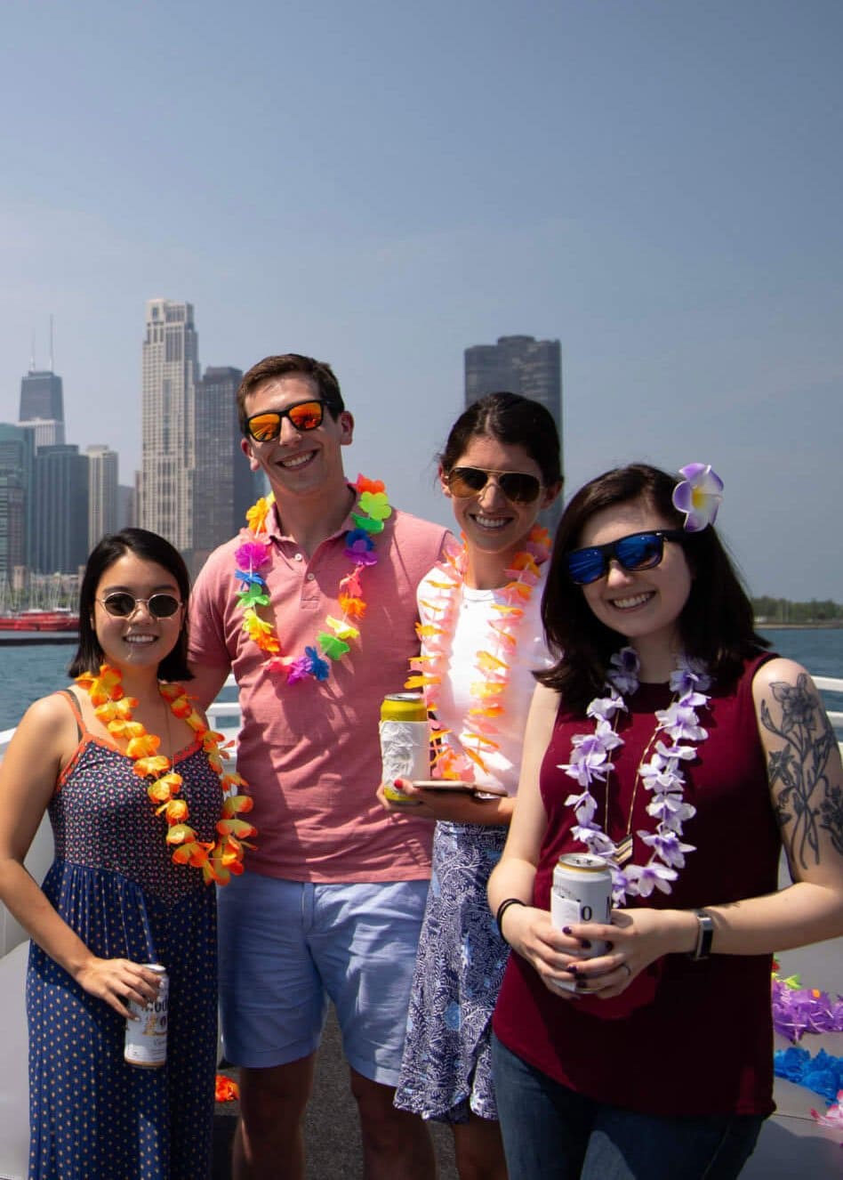 P/E team members enjoy a summer event on a boat on Lake Michigan with the Chicago skyline behind them.