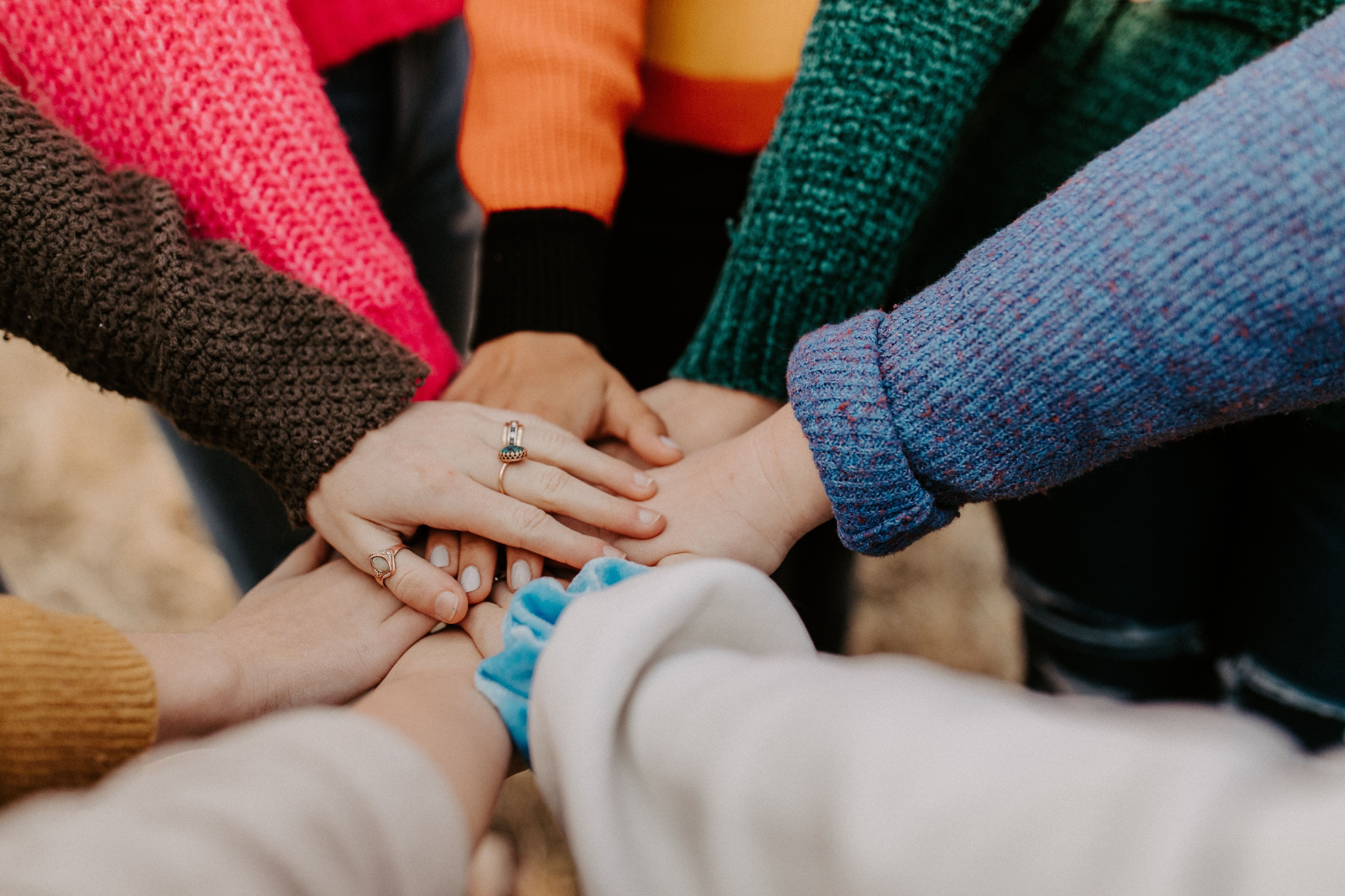 hands of diverse individuals in a huddle
