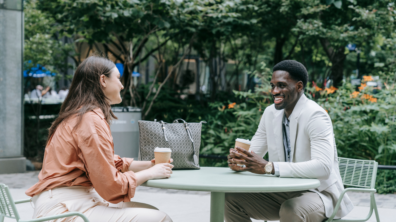 young black male having coffee with a white young female