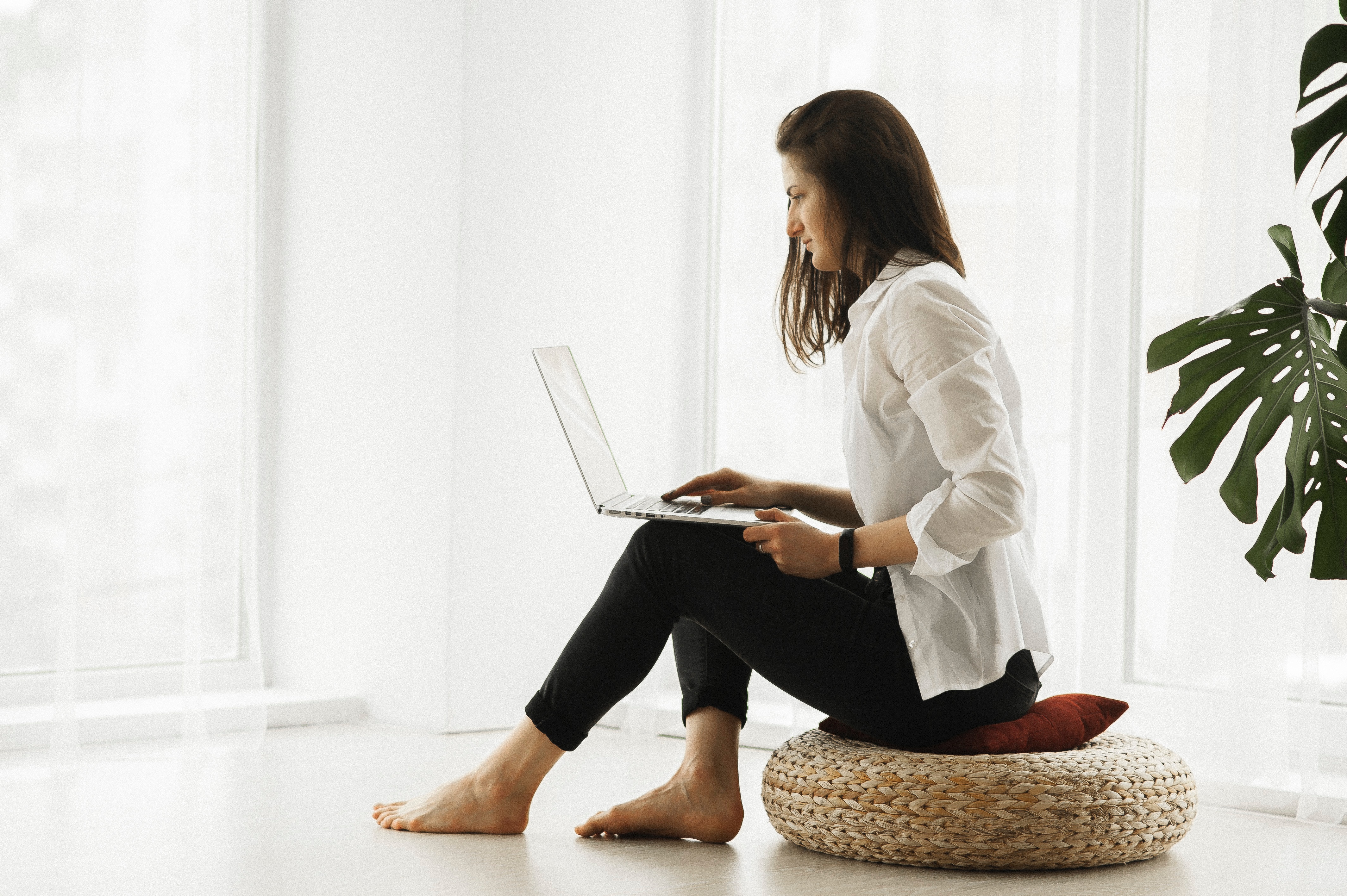 woman sitting on the floor on a laptop