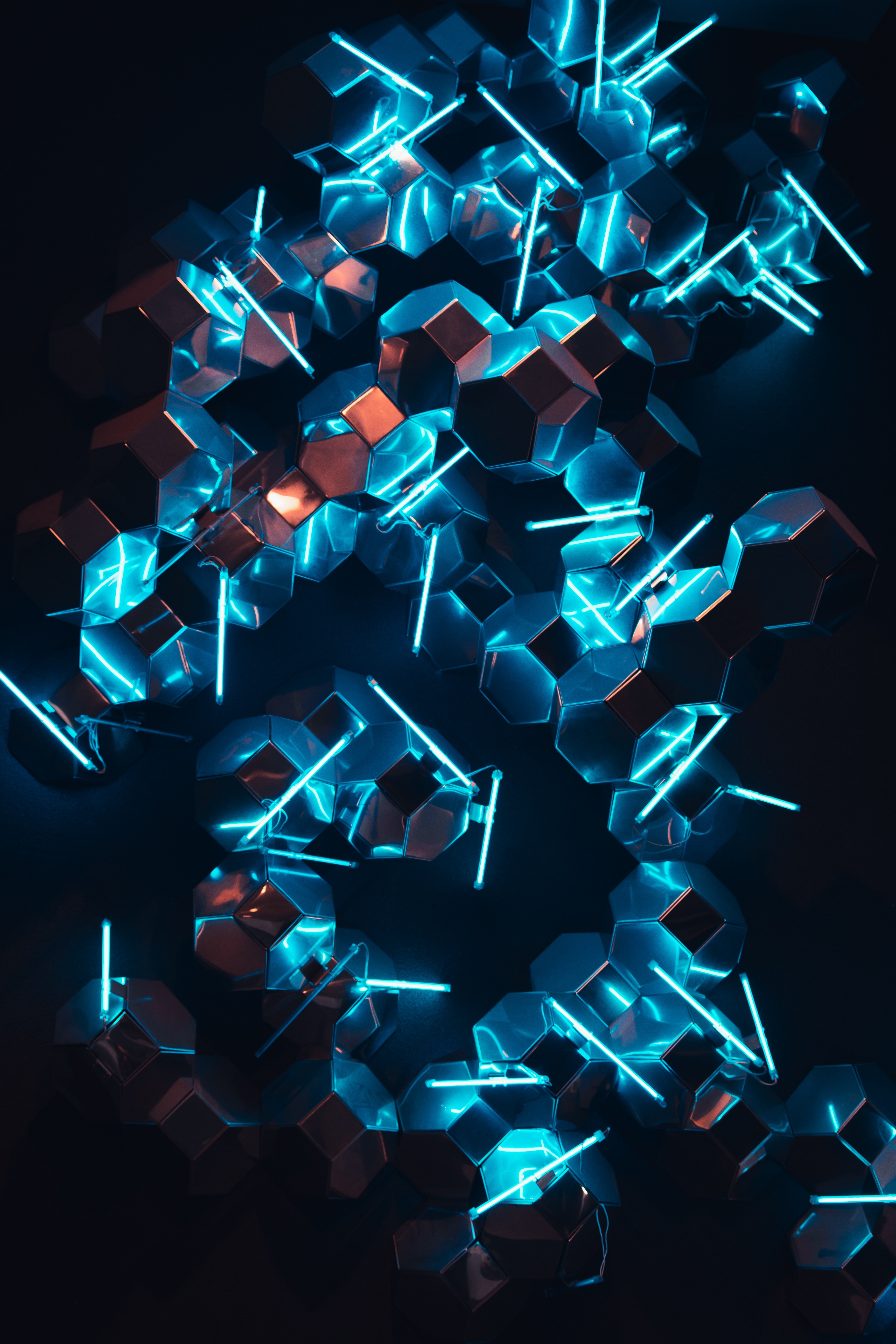 A geometric pattern of blue lights and reflective glass.