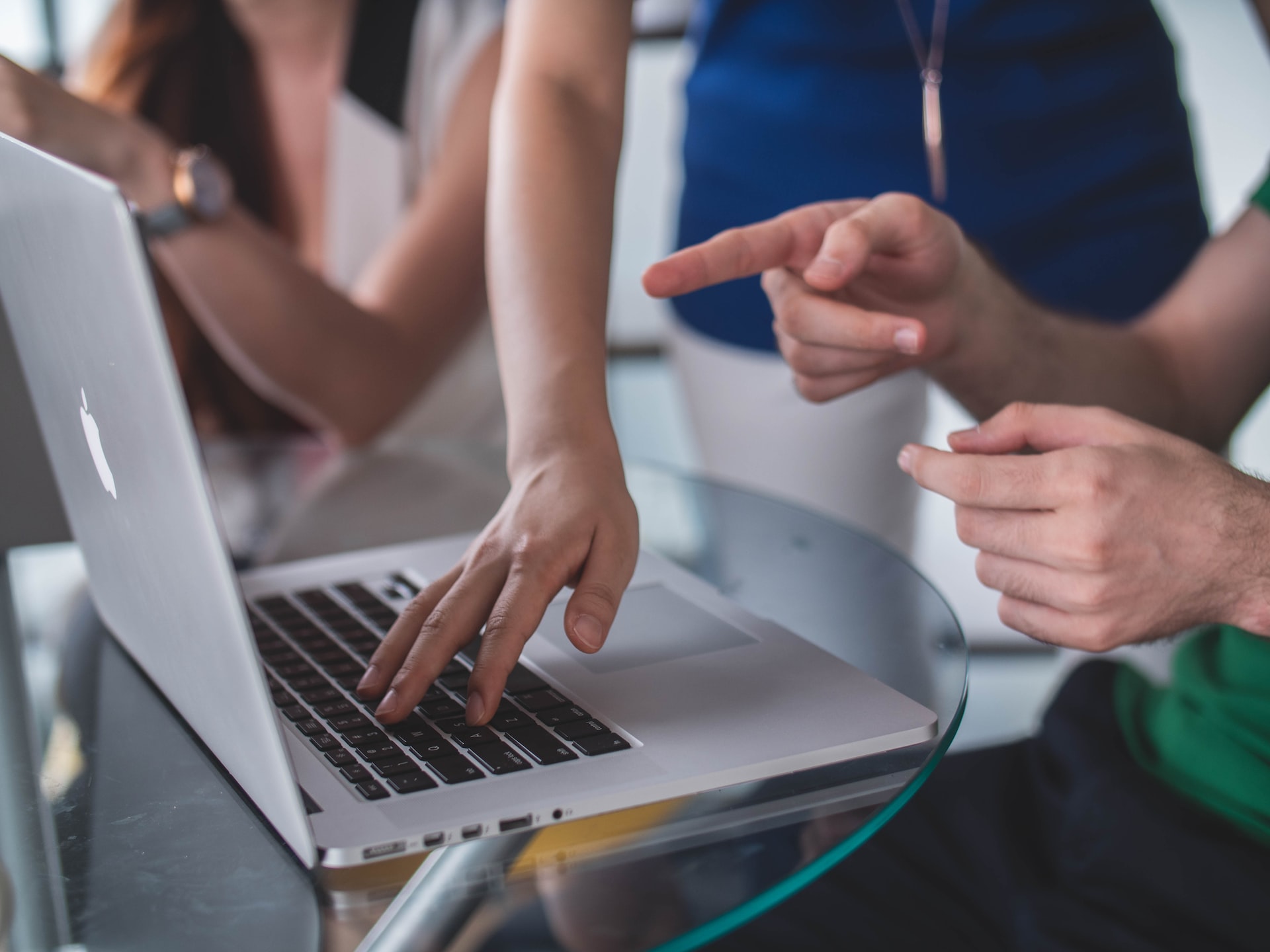 two people working together on a computer 