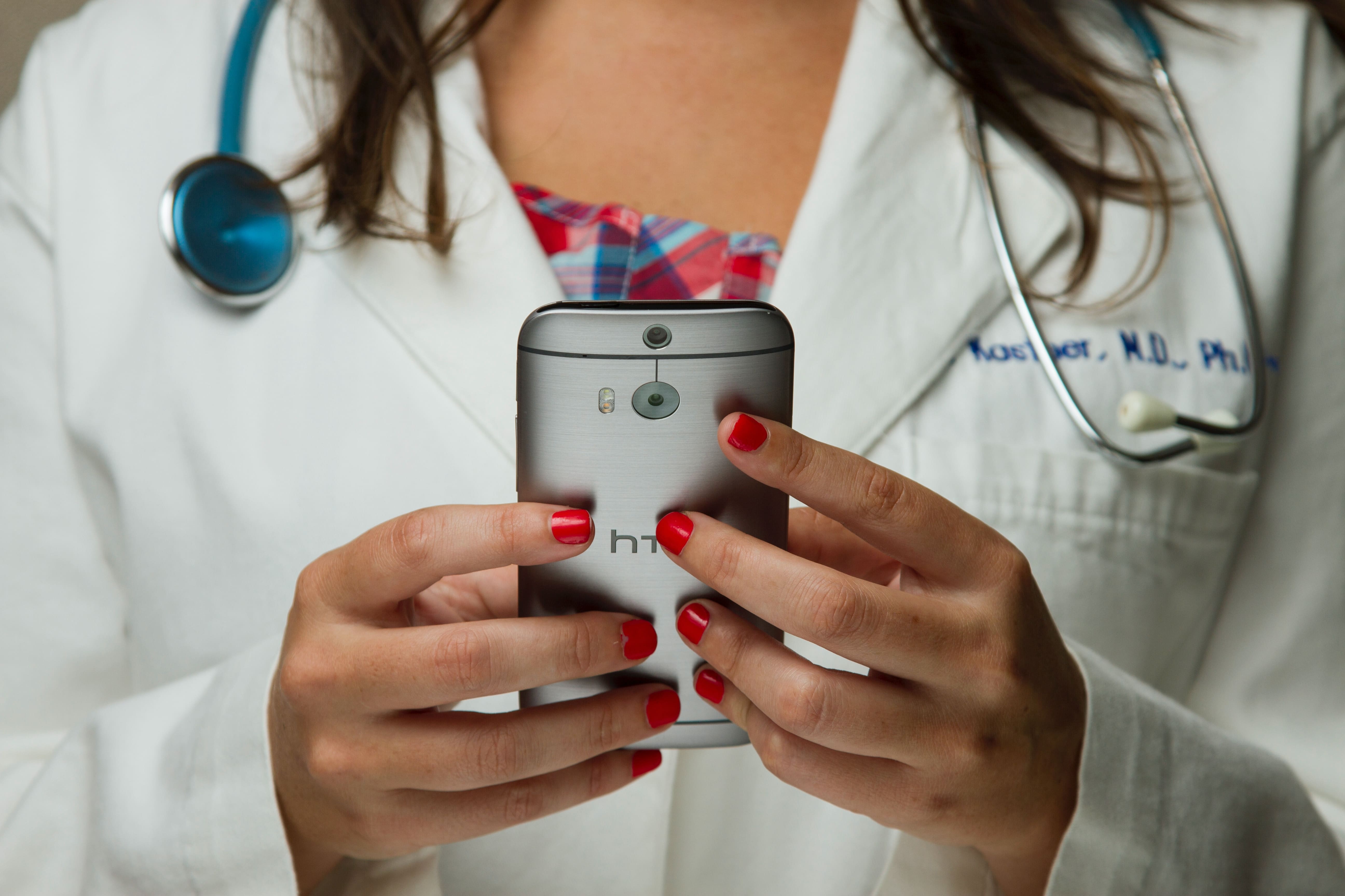 female doctor holding a mobile phone