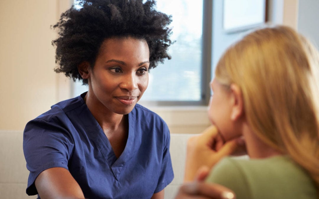 young black doctor with young patient