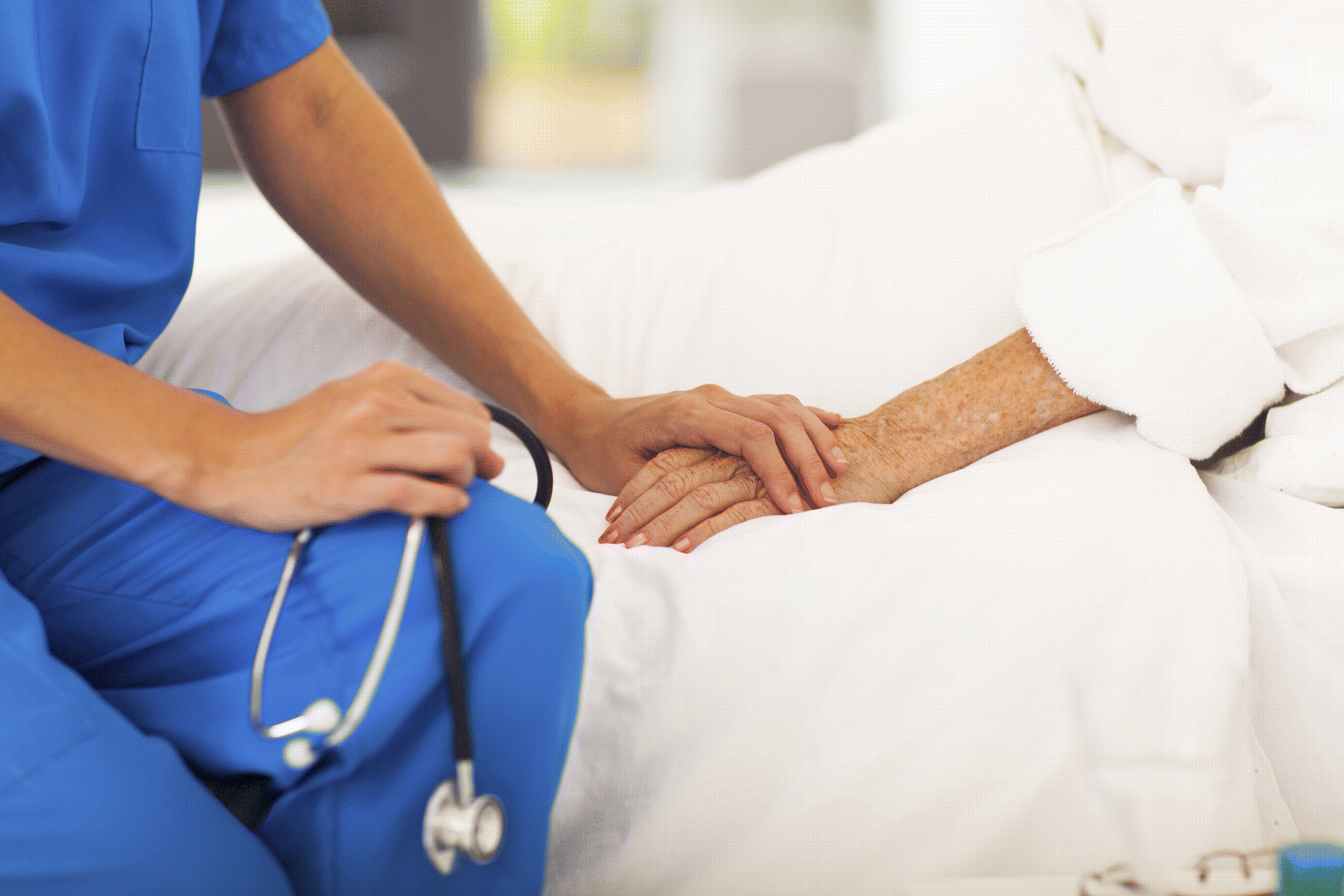 doctor placing hand over patient's hand