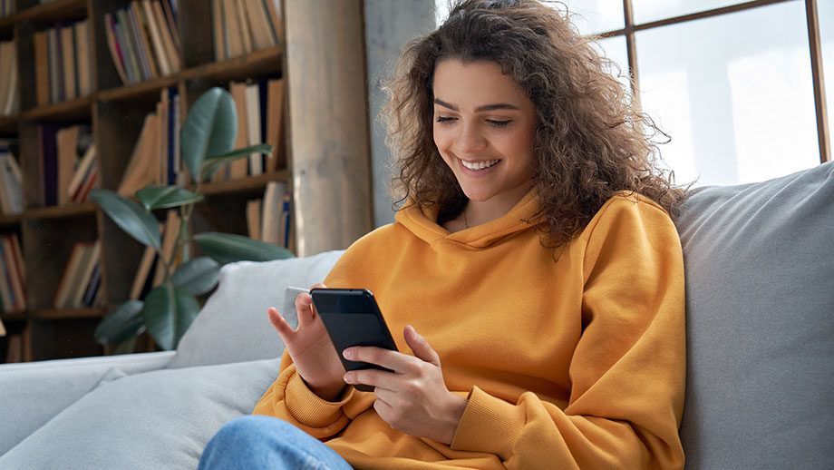 young woman smiling at her phone